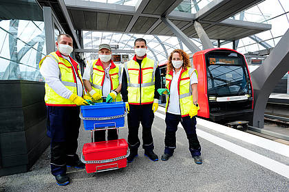 Mitarbeiter des Hochbahn-Hygieneteams posieren am Bahnsteg.